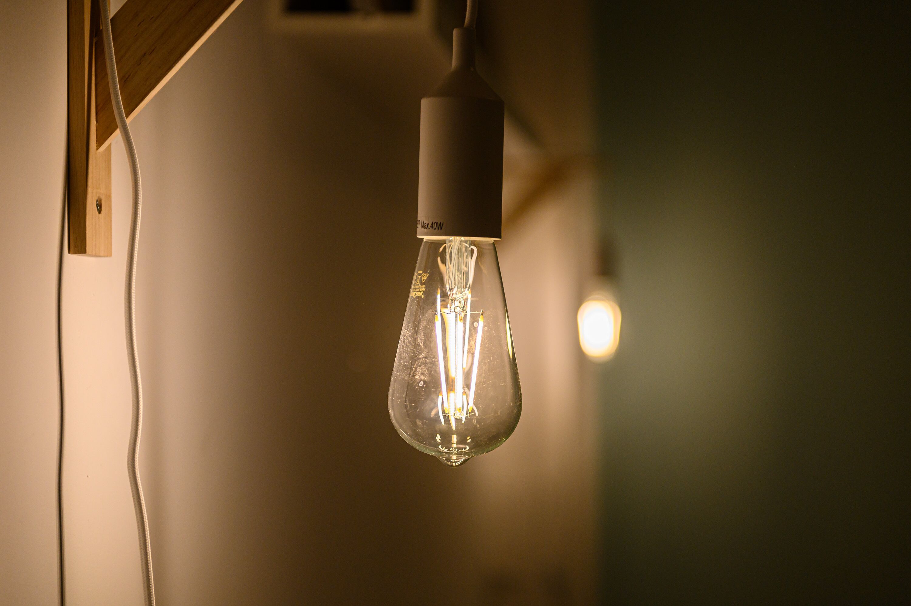 A single light bulb hanging from a wooden fixture.