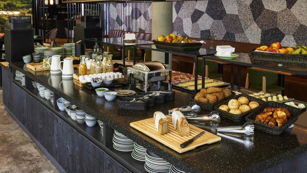 A buffet setup with various food items, including fruits, pastries, and condiments. - Ibis Styles Singen (Singen)