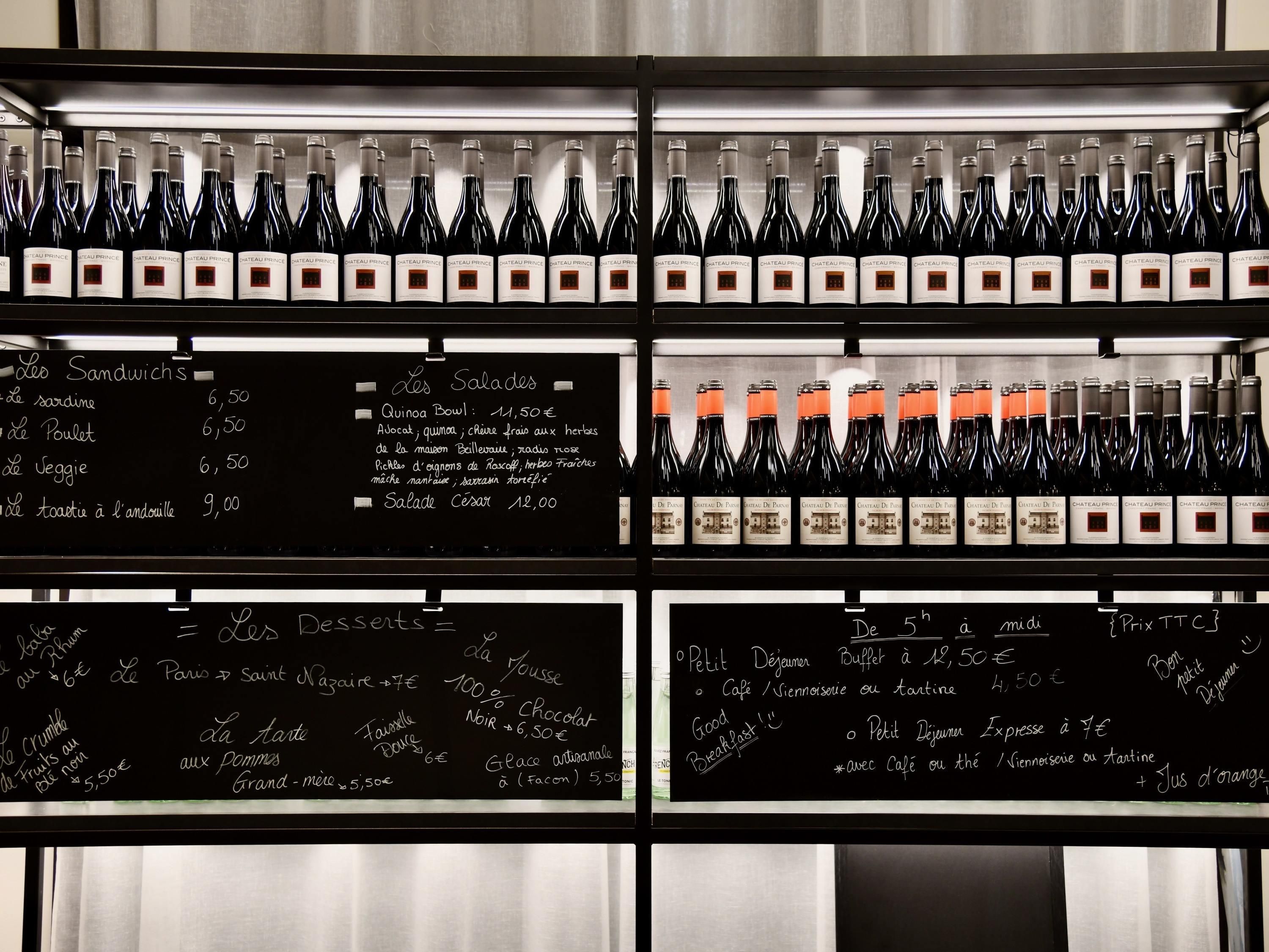 A wine display with bottles labeled 'Chateau Prince' and a menu board with food and drink prices.