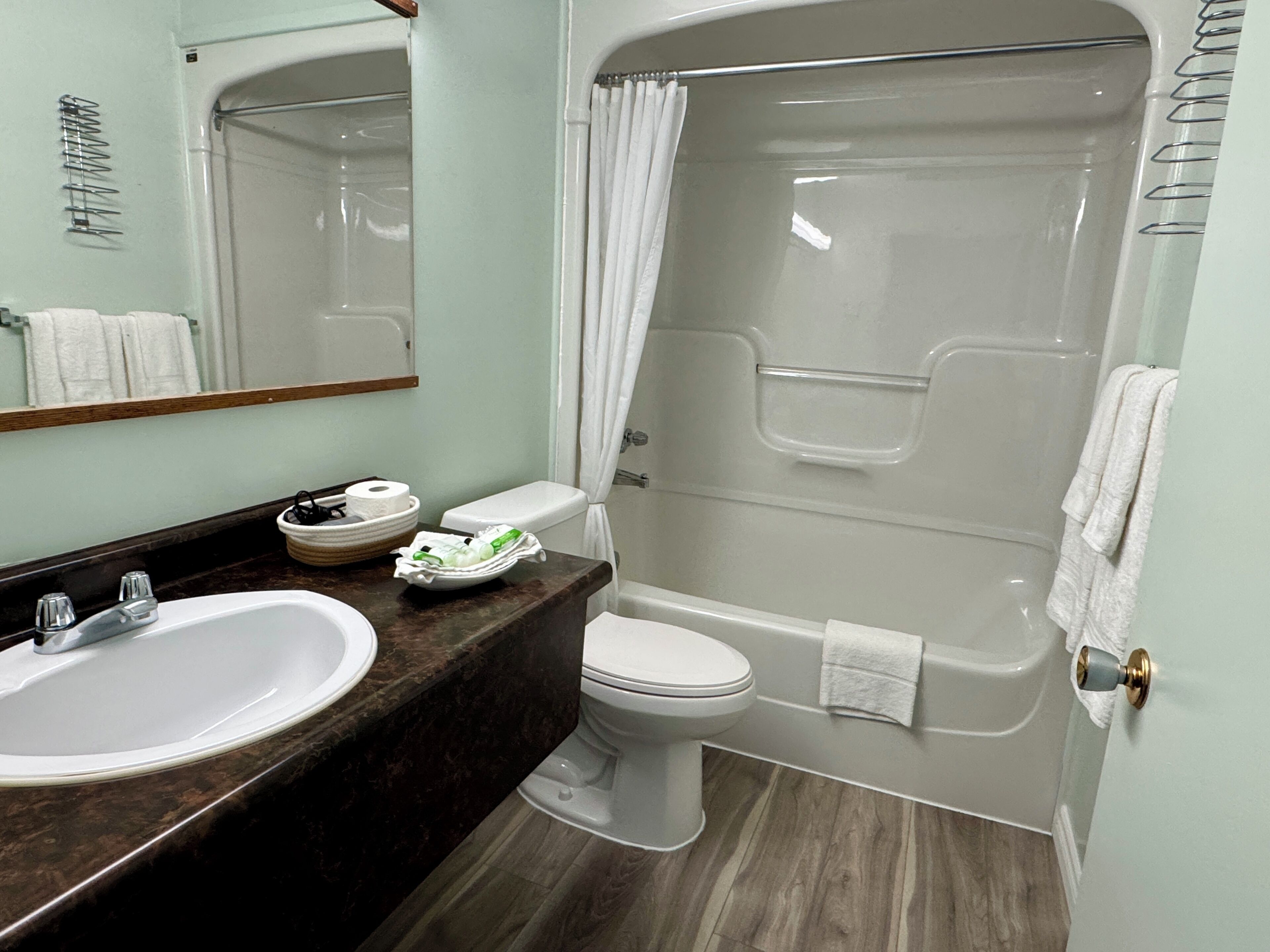 A bathroom with a sink, toilet, and bathtub.