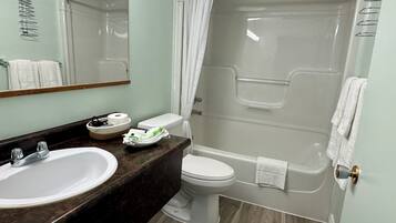 A bathroom with a sink, toilet, and bathtub.