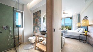 A modern bathroom with a glass shower enclosure, a toilet, and a sink with a decorative bowl. - Oleas Suite Sun Private Pool (Heraklion)