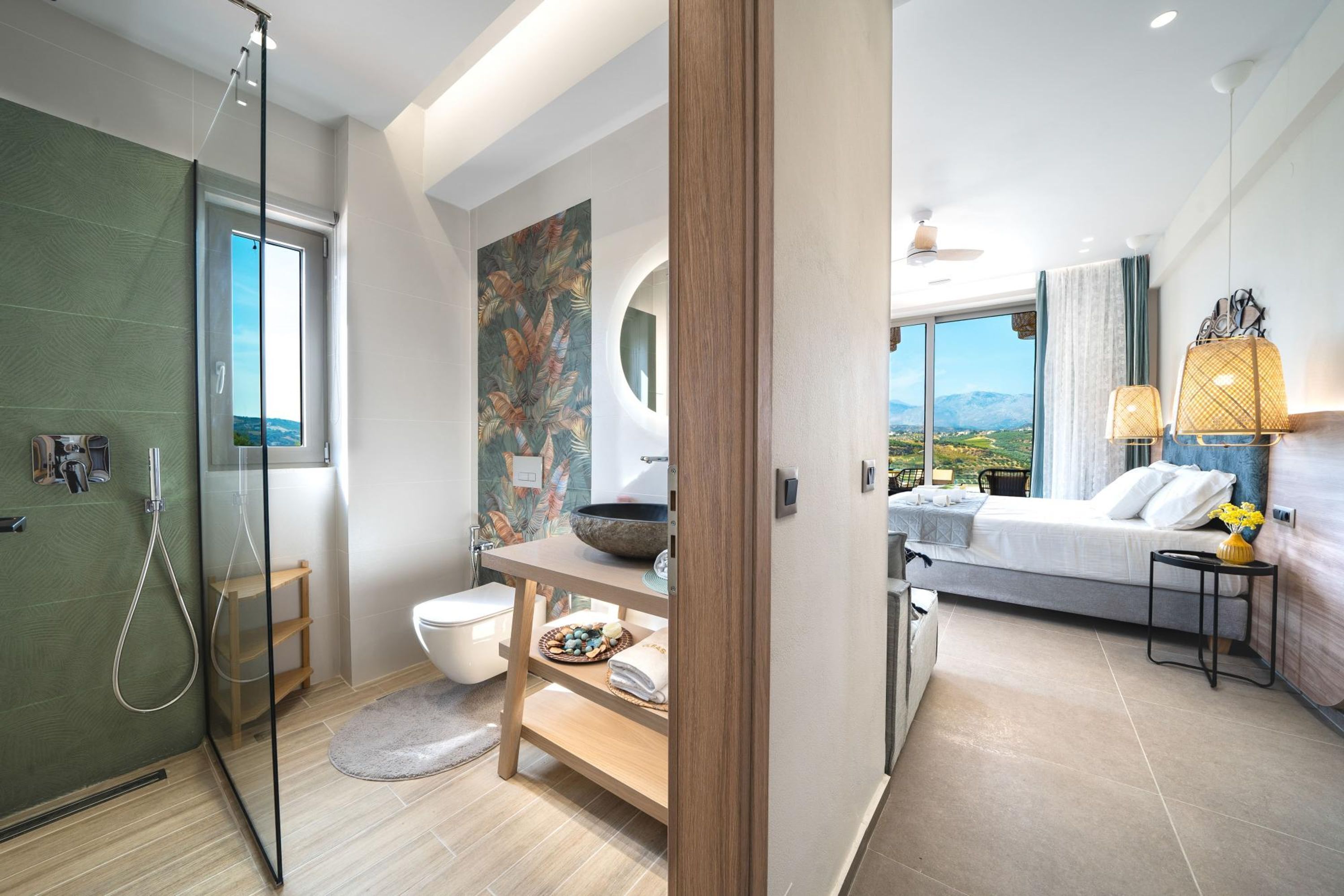 A modern bathroom with a glass shower enclosure, a toilet, and a sink with a decorative bowl.