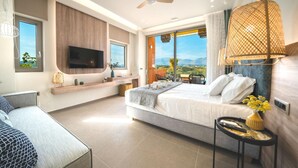 A modern hotel room with a large bed, a TV mounted on the wall, a balcony with a view of the countryside, and a ceiling fan. - Oleas Suite Sun Private Pool (Heraklion)