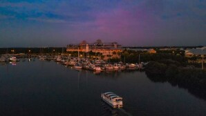 A large hotel with multiple buildings and a marina with boats.