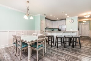 Enjoy meals in the kitchen and dining area with a glass-top table and comfortable seating for four.