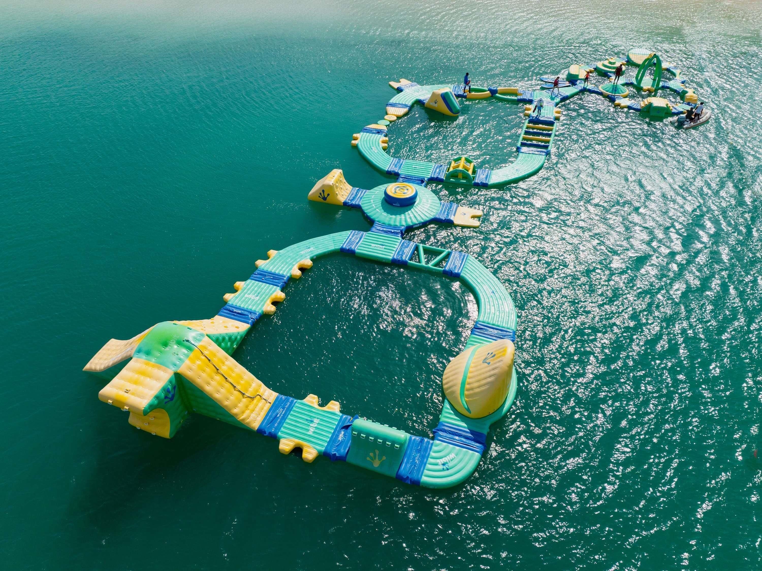 An aerial view of a floating structure with interconnected platforms and walkways over water.