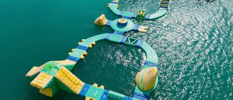 An aerial view of a floating structure with interconnected platforms and walkways over water.