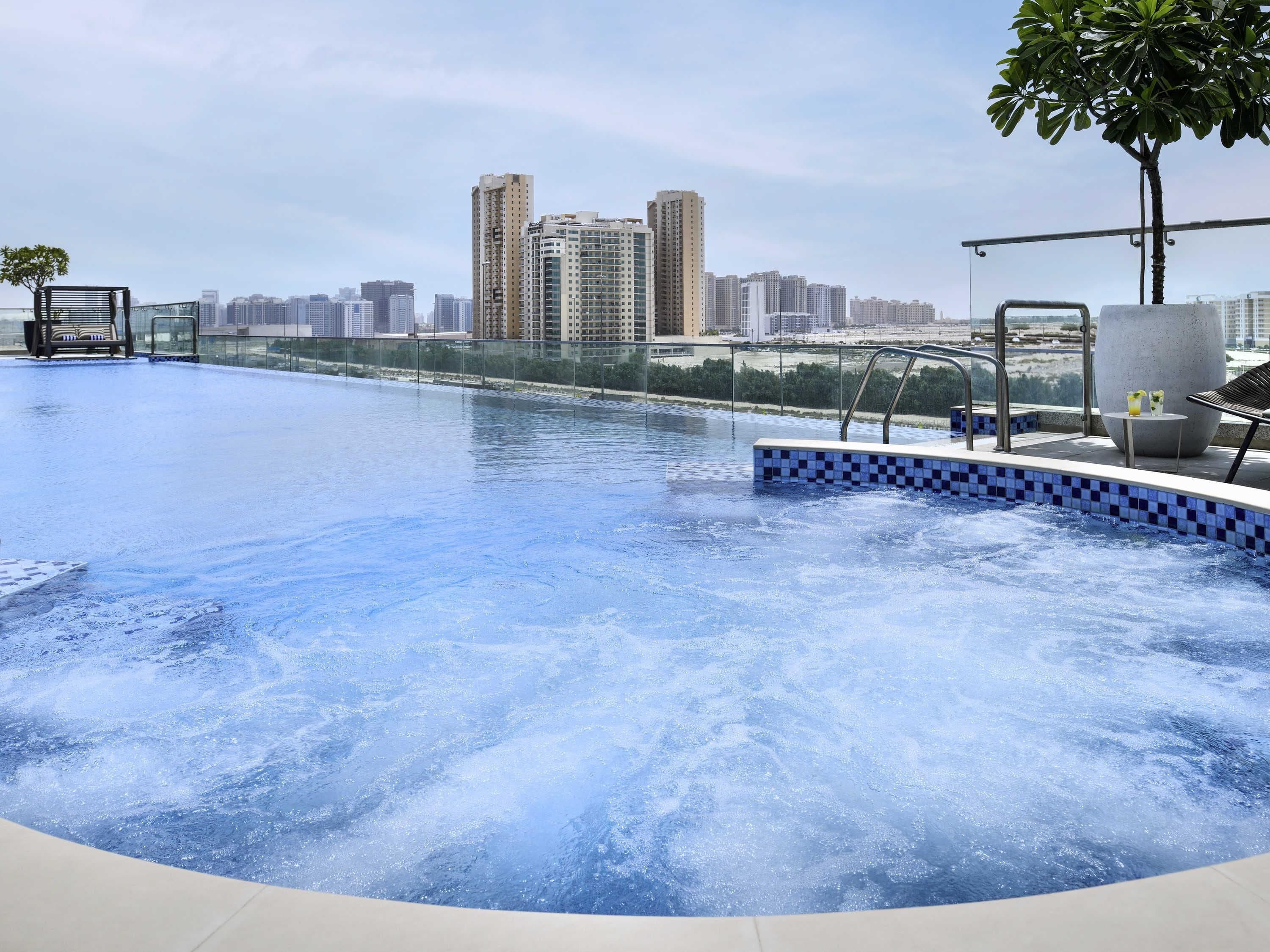 A swimming pool with a view of high-rise buildings in the background.