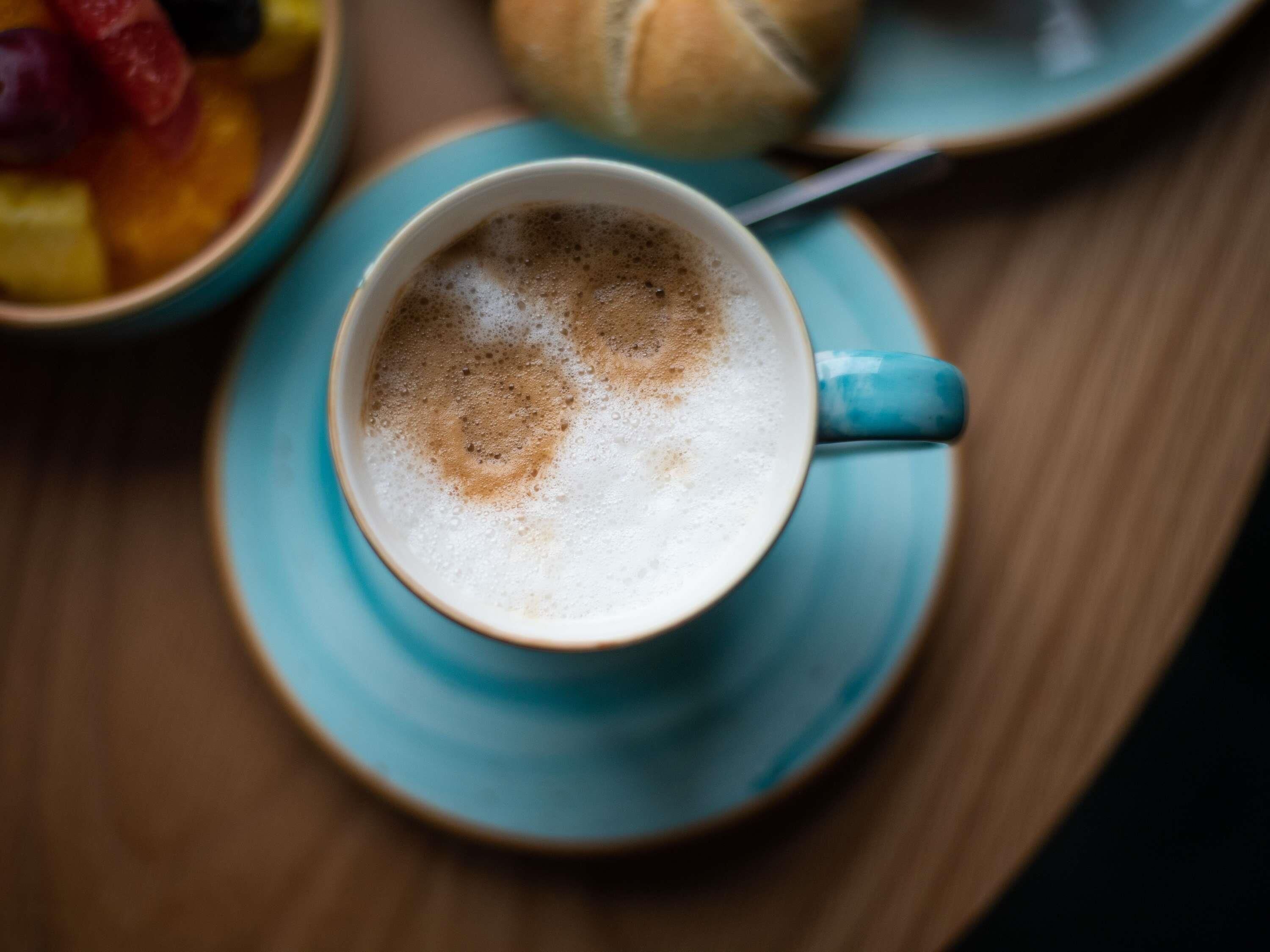 A cup of coffee on a saucer.