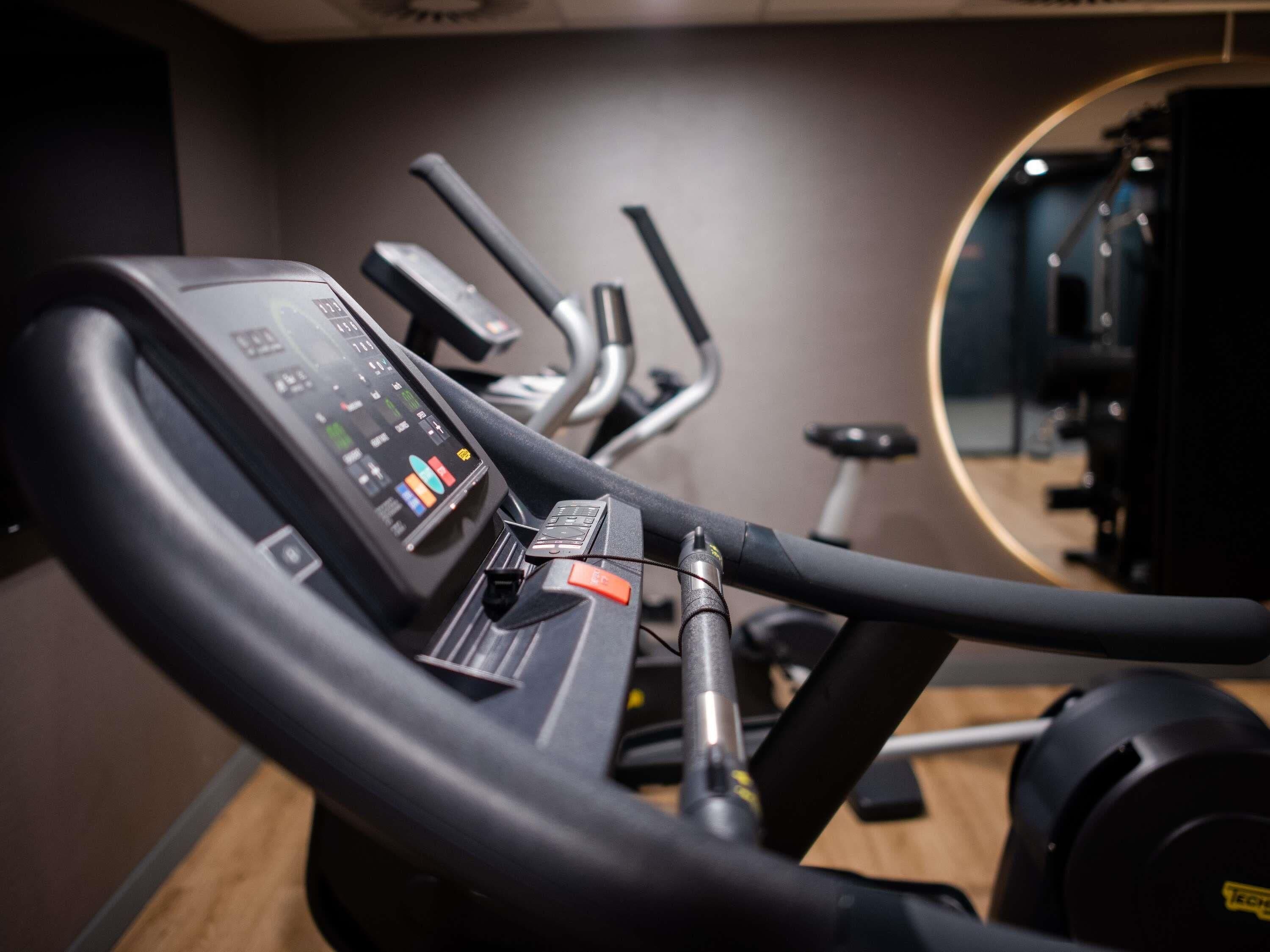 An exercise machine with a digital display and a mirror.