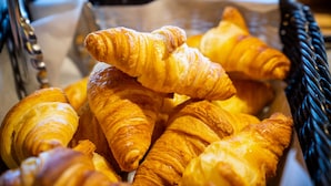 A basket filled with golden-brown croissants. - Ibis Budget Reims Parc Des Expositions (Reims)