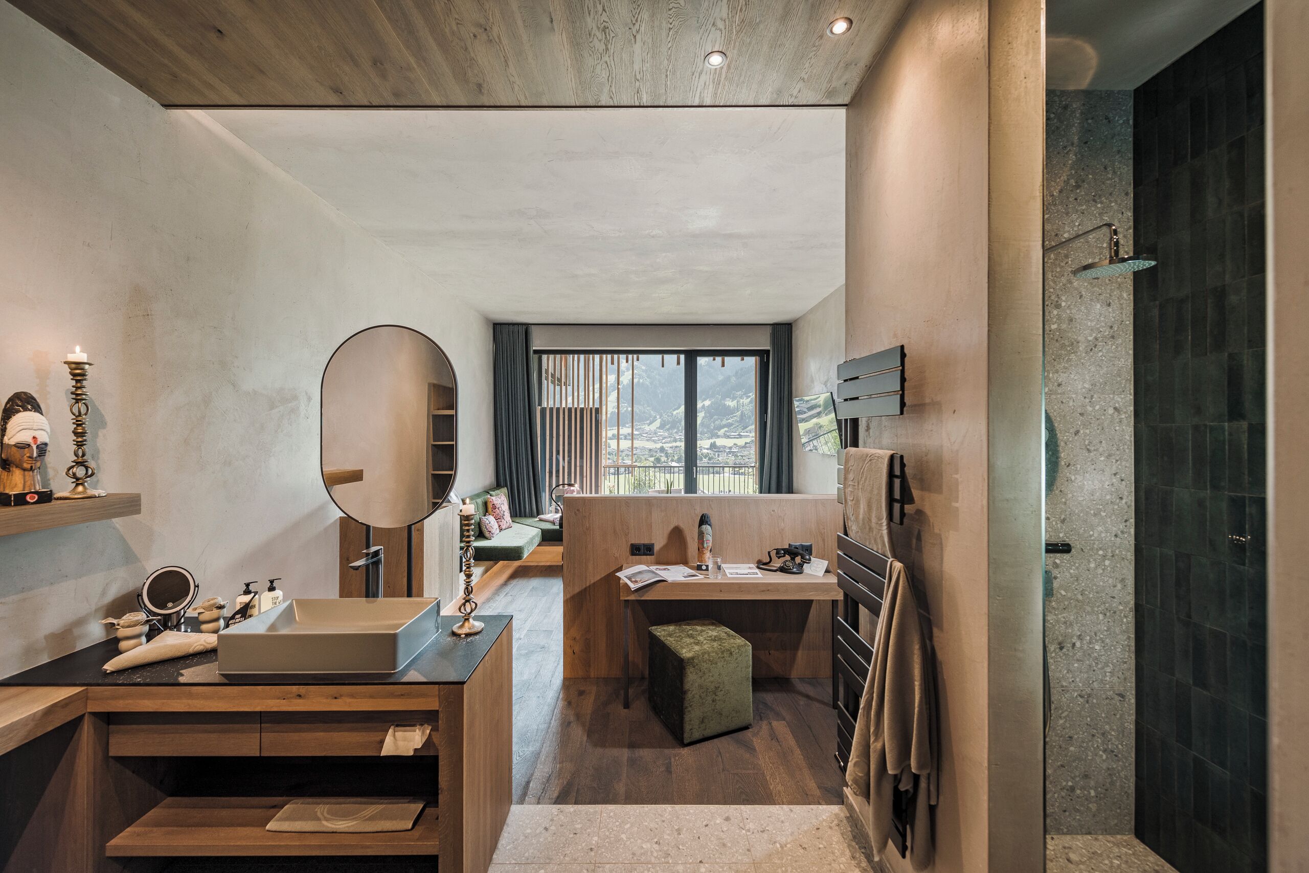 A modern bathroom with a wooden vanity, a large mirror, a bathtub, and a shower area.