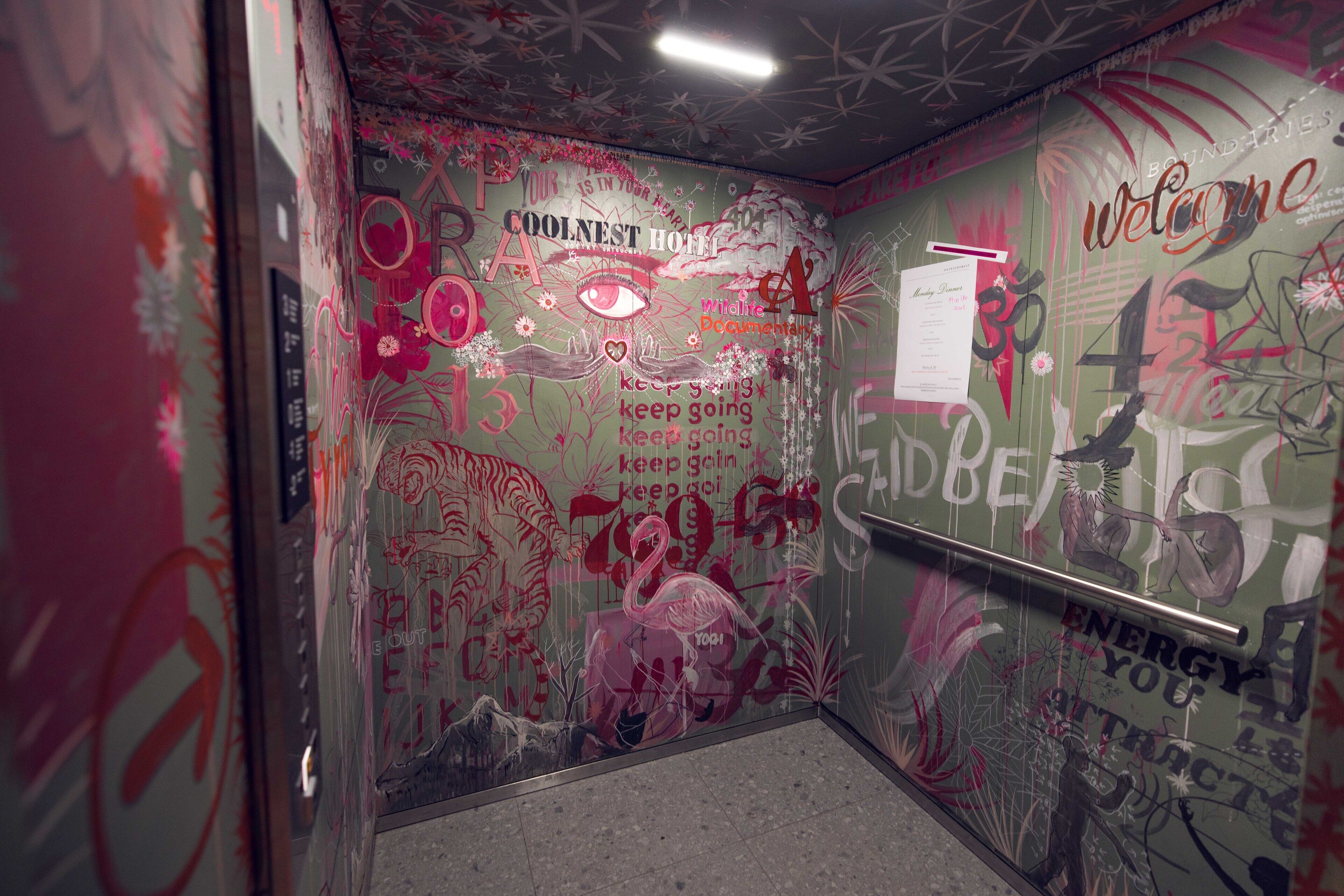 A wall with graffiti and text, including 'COOLNESS' and 'WELCOME'.