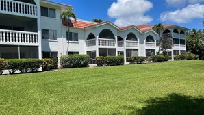 A multi-story hotel with a flat roof, balconies, and a well-maintained lawn. - Breakers West B3 | Stunning and Spacious West Gulf Drive Residence | Steps to Beach (Sanibel)
