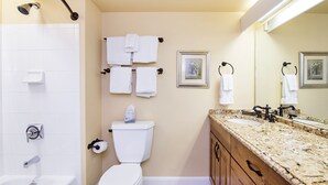 A bathroom with a white toilet, a sink with a granite countertop, and a shower with a handheld showerhead. - Blue Mesa Lodge 32A by AvantStay | Located In The Heart Of Mountain Village (Telluride)