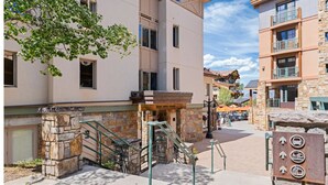 A multi-story building with a stone staircase leading to an entrance. - Blue Mesa Lodge 40B by AvantStay | Ski In/ Ski Out Unit w/ Balcony! (Telluride)