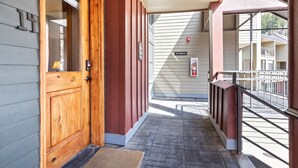 A wooden door with a glass panel, a mailbox, and a 'No Smoking' sign on a building facade. - Cimarron Lodge 14 by AvantStay | Ski-In/Ski-Out Property w/ Two Hot Tubs! (Telluride)