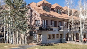 A two-story building with a balcony on the second floor, a stone facade, and a sign that reads "Plaza." - Columbia Place 5 by AvantStay | Ski-In/Ski-Out Unit in Great Location! (Mountain Village)