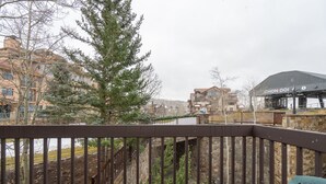 A balcony with a view of a stone staircase and buildings in the background. - Columbia Place 5 by AvantStay | Ski-In/Ski-Out Unit in Great Location! (Mountain Village)
