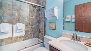 A bathroom with a glass-enclosed shower, a bathtub, a toilet, and a sink with a vanity. - Ghostriders 5 by AvantStay | 2 Bedroom Condo Near Main Street, Hiking & Skiing | (Telluride)