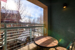 Enjoy the serene view from this balcony with a metal railing, perfect for taking in the surrounding landscape.