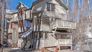 A multi-story building with a balcony, a staircase, and a porch. - Plunge A by AvantStay | Stunning Views & A Block From Lift #7 (Telluride)