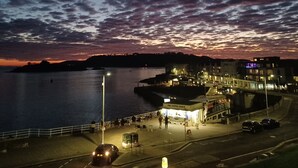 A waterfront scene with a coffee shop and buildings along the shore. - The Craft House (Plymouth)