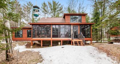 Riverfront vacation home with a dock, wood stove, full kitchen, & firepit