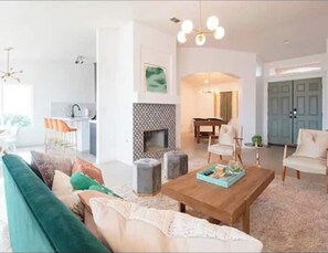 Relax in this stylish living area with a plush sofa, coffee table, and fireplace.