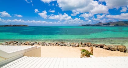 Sweet Home SXM Baie Nettlé Feet in the water on the beach