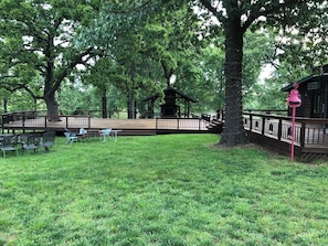 A park with a gazebo, picnic tables, and a wooden deck. - Seven Oaks sleeps 8, outdoor adventures (Quapaw)