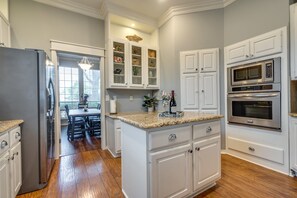 Enjoy cooking in this well-equipped kitchen with a refrigerator, microwave, and oven.