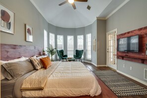 Relax in a spacious bedroom with a large bed and comfortable seating area, perfect for unwinding.
