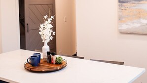 A modern kitchen with a white countertop, dark cabinets, and a sliding barn door. - Ridge Point | Walk to Glen Arbor | Pet-Friendly | Close to Sleeping Bear Dunes (Glen Arbor)