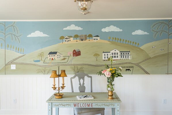 A mural of a rural landscape with houses and trees. - The Millbrook Inn (Millbrook)