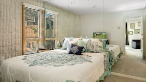 A bedroom with a large bed, a window with blinds, and a door leading to another room. - Lionshead Village Condo, Perfect Location 100 Yards from Slopes, Hot Tub! (Vail)