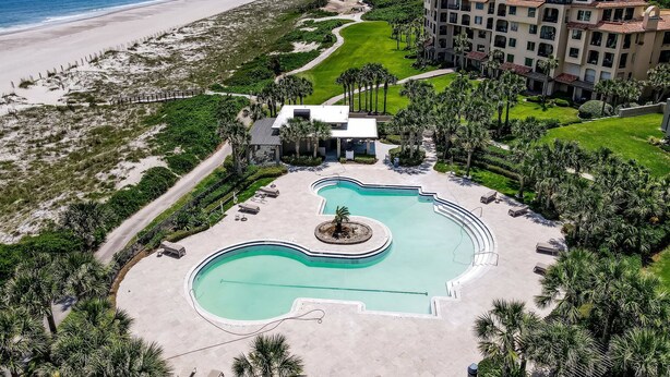 A resort with a swimming pool, beachfront, and multiple buildings. - RARE Direct Oceanfront Condo with TWO private balconies within OMNI resort (Fernandina Beach)