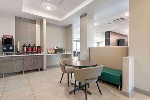 A modern cafe with a counter, coffee machines, and seating area. - Best Western Plus Grand Rapids MN (Grand Rapids)
