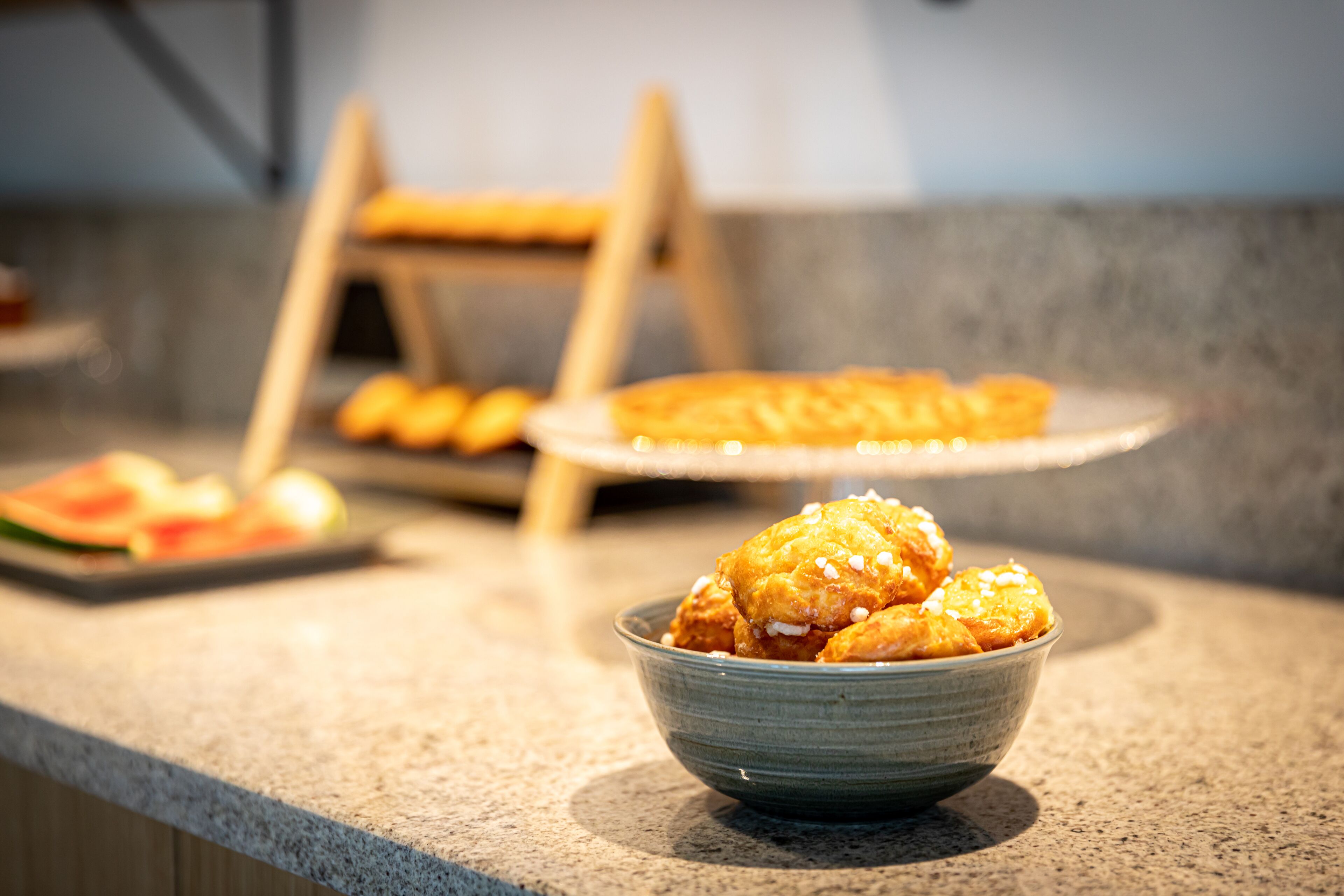 A bowl of food on a countertop with a blurred background.