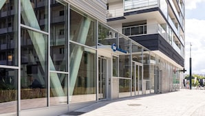 A modern building with large glass windows and a sign reading "Best Upscale Hotel".