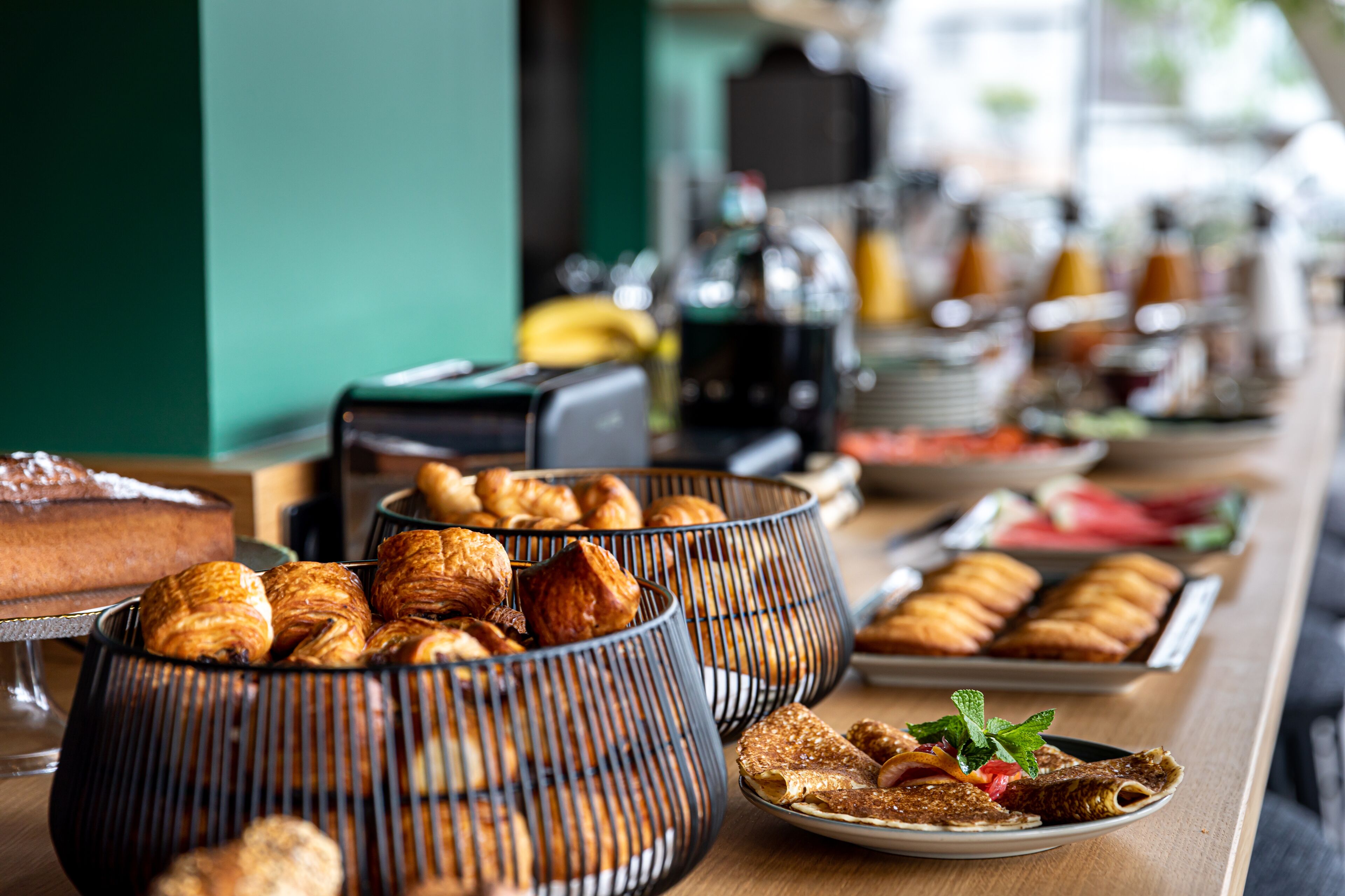 A buffet table with various pastries and desserts.