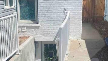 A house with a white exterior, a small front porch, and a visible door.