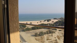 A view from a window overlooking a beach with a clear sky. - Magic Suite Mahboula-5 (Mahboula)