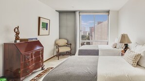 A bedroom with a large window, a wooden dresser, a chair, a bed, and a lamp. - Amazing PH w/great terrace in the heart of Condesa (Mexico)