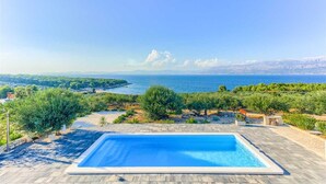 A rectangular swimming pool with a clear view of the sea and distant mountains. - Villa Serenity - Silence, view and heated pool by MyWaycation (Supetar)
