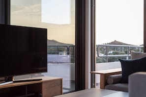 Signature Apartment, 1 Queen Bed with Sofa bed, Balcony, Sea View | Living area | 55-inch Smart TV with digital channels, TV, fireplace - Sounio Panoramic Loft (Lavreotiki)