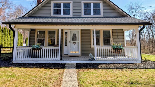 A two-story house with a front porch, a chimney, and a small dog statue. - Fully Fenced & Dog Friendly - Minutes to Liberty Mtn & Gettysburg (Gettysburg)