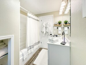 Combined shower/tub, hair dryer, towels, soap