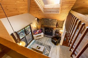 Cozy room with a fireplace, comfortable seating area, and a large window.
